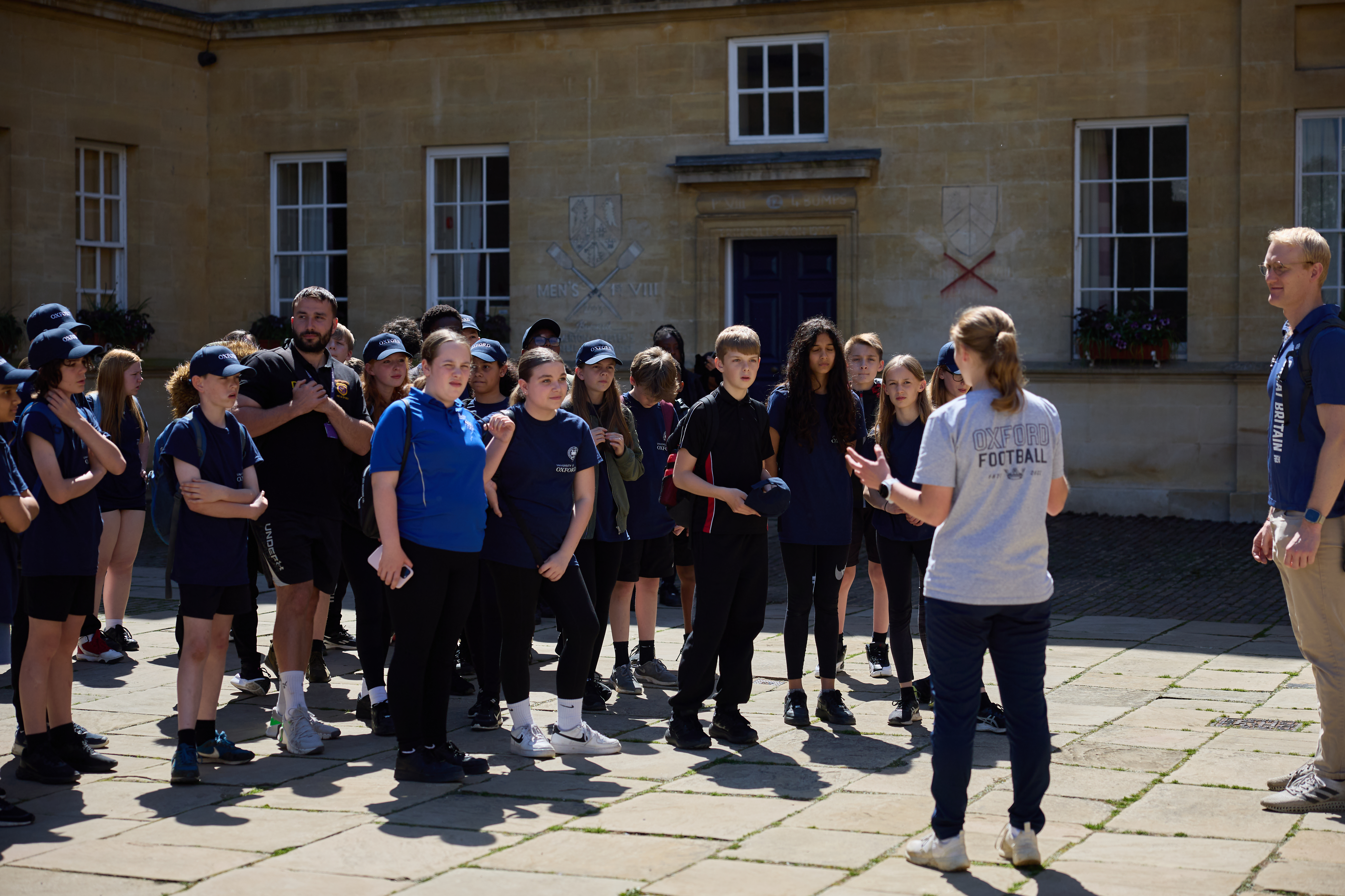 Oliver Cook supervising sports fellows leading an activity