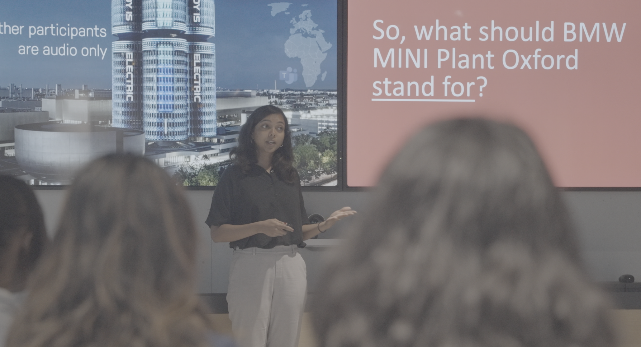 Reema Mohamed presenting to a audience at BMW Group MINI Plant Oxford