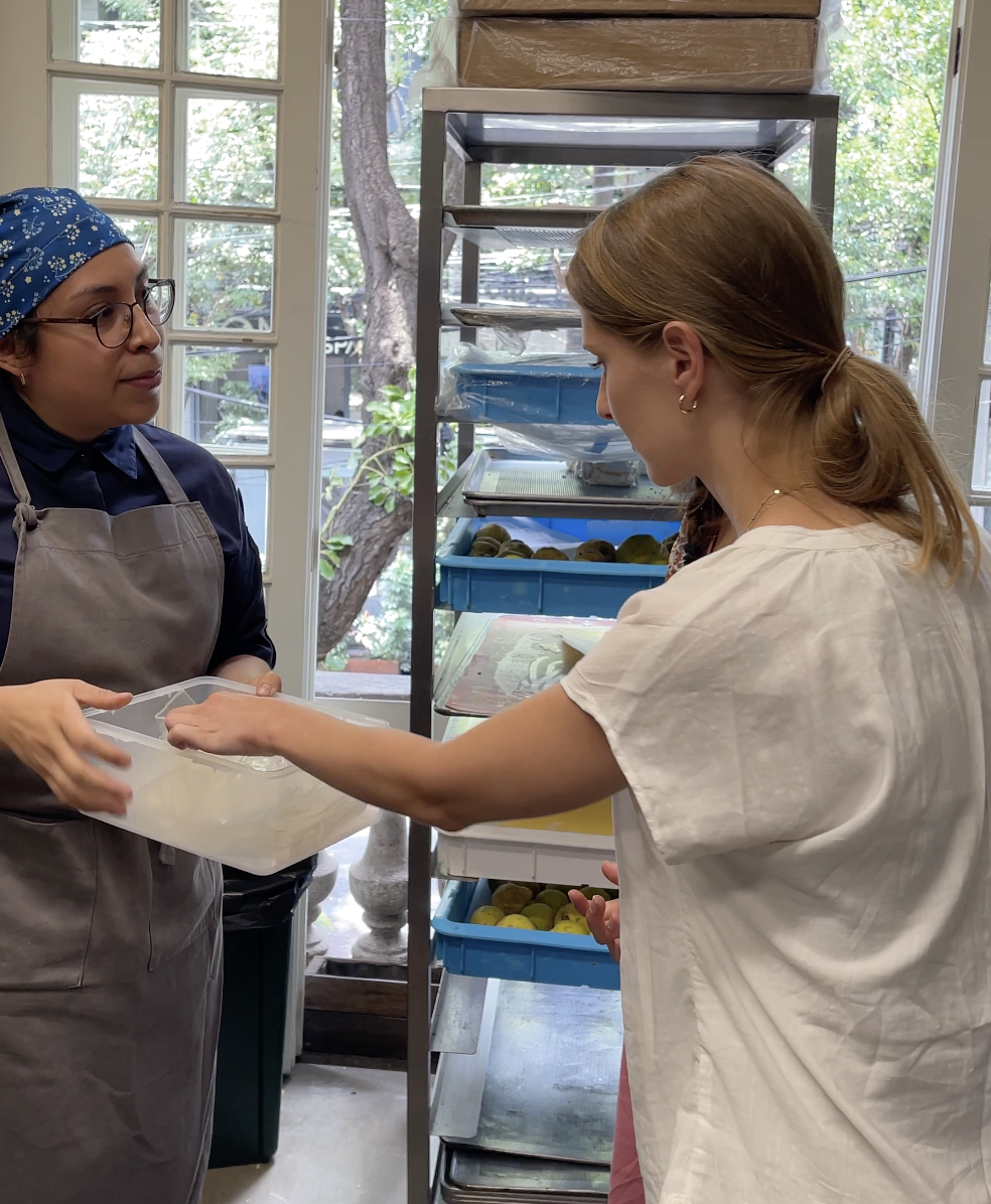 Fellows looking at catering Items in container