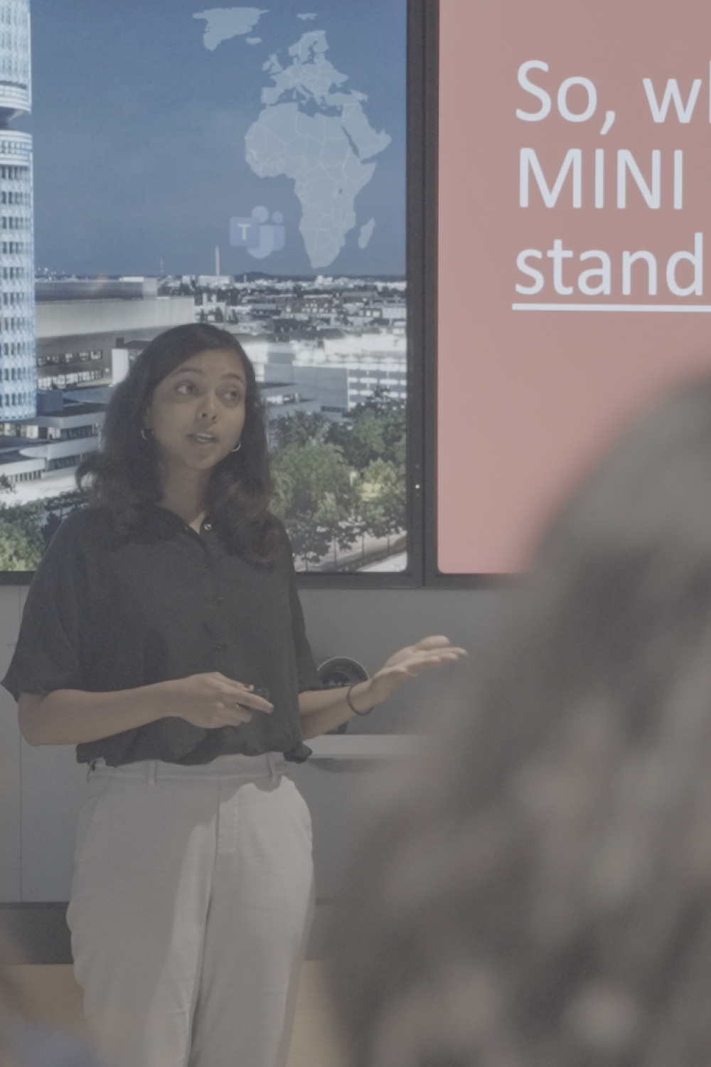 Reema Mohamed presenting to a audience at BMW Group MINI Plant Oxford