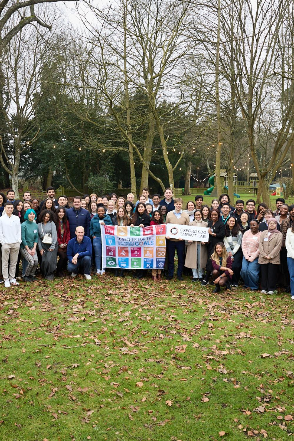 2025 Fellows Group Shot with SDG Flag and Lab Sign