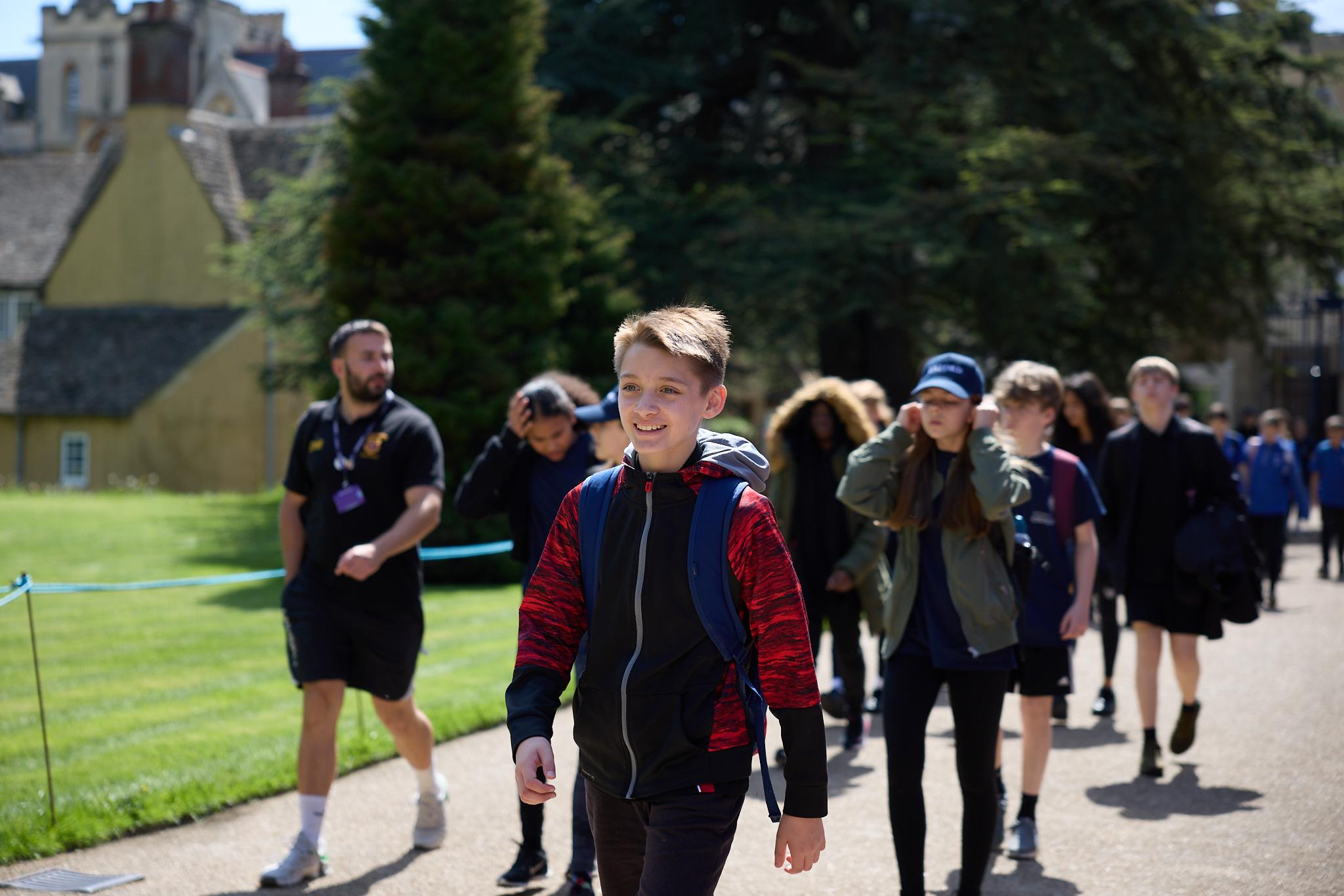 Pupils walking to college for lunch, pupil at front smiling