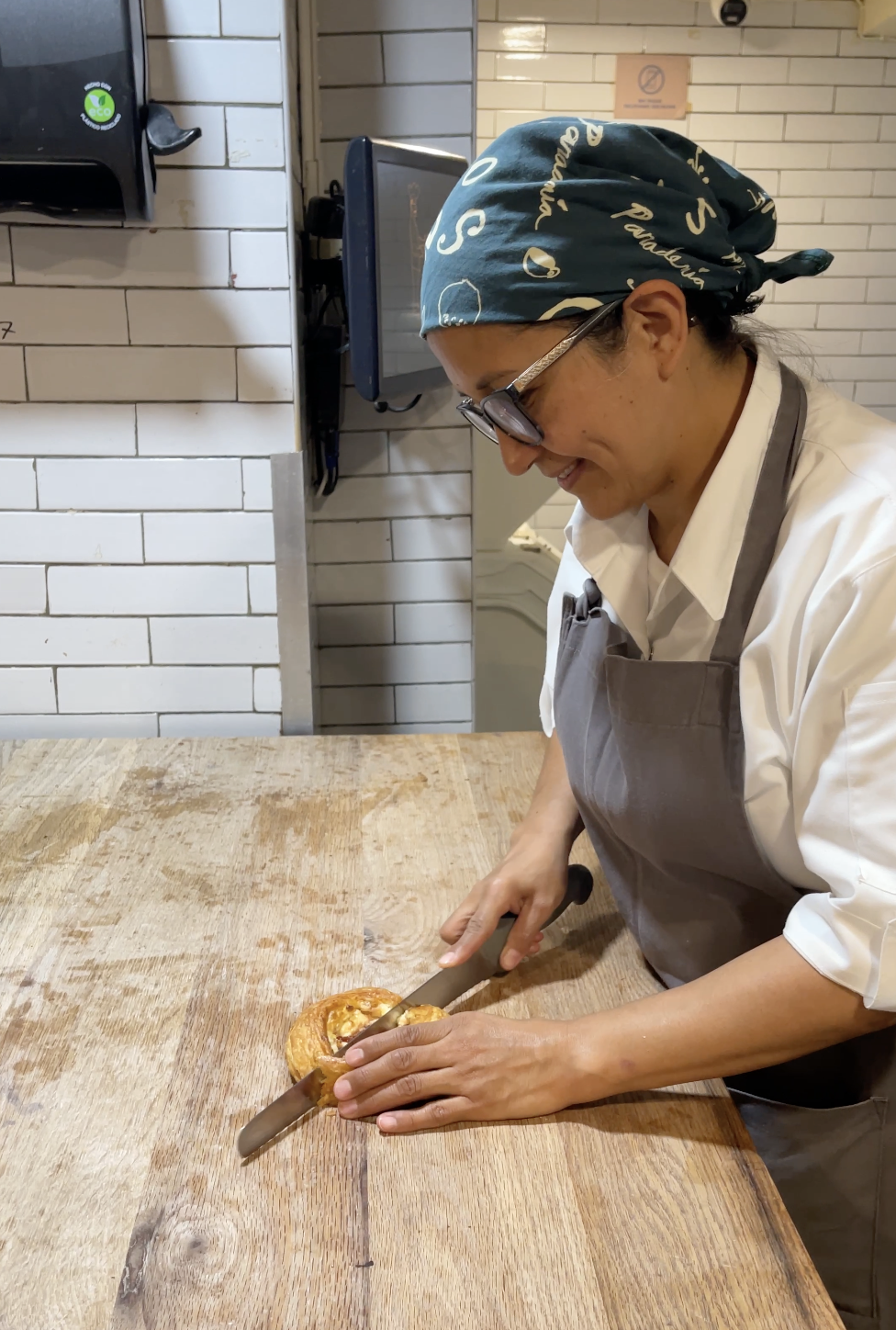 Kitchen staff cutting a pastry