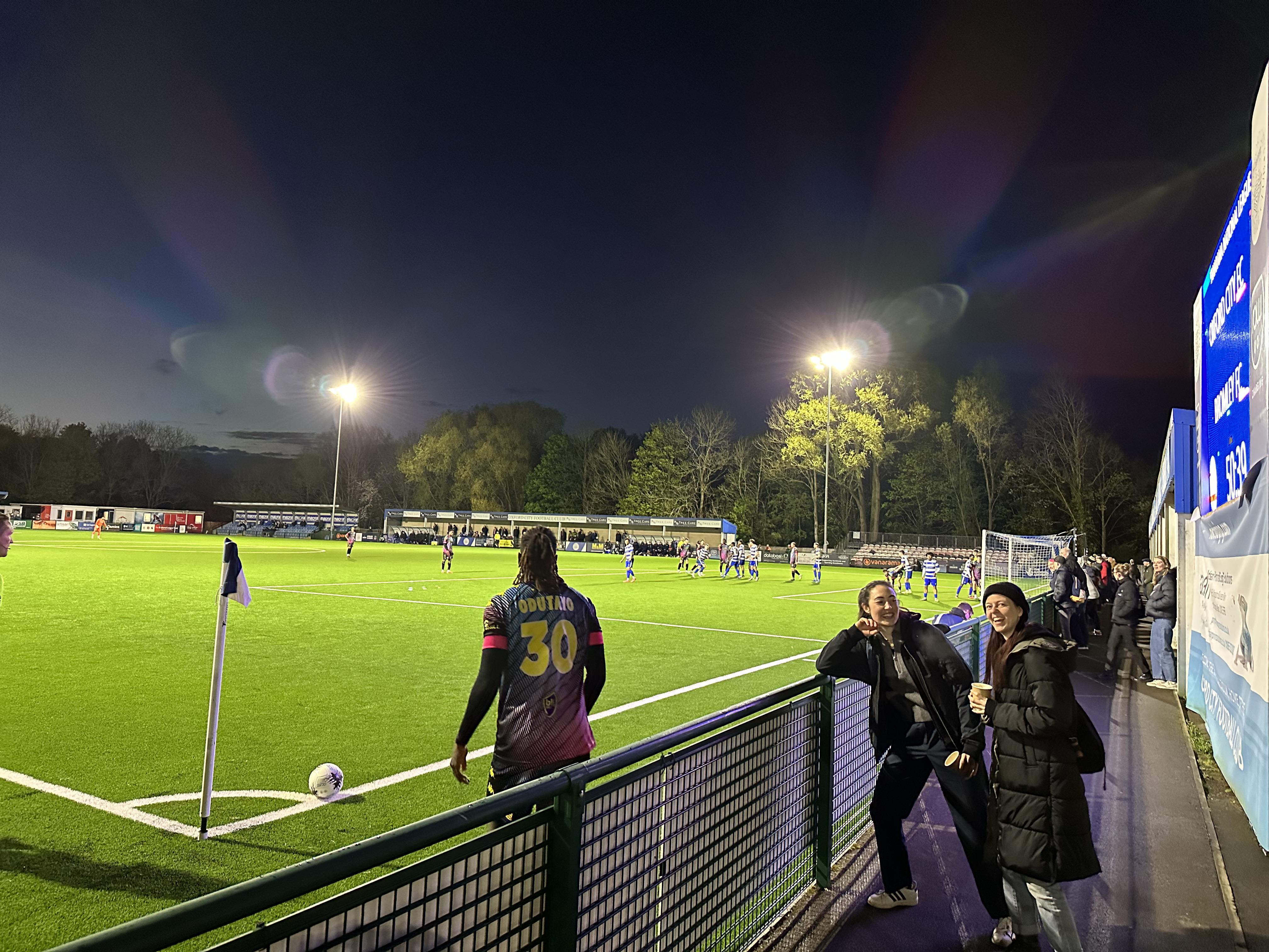 Fellows Isabelle Haynes and Mathilde Ritman watching game at Oxford City Football Club